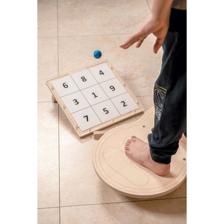 Child uses a Balance set - board and target stand